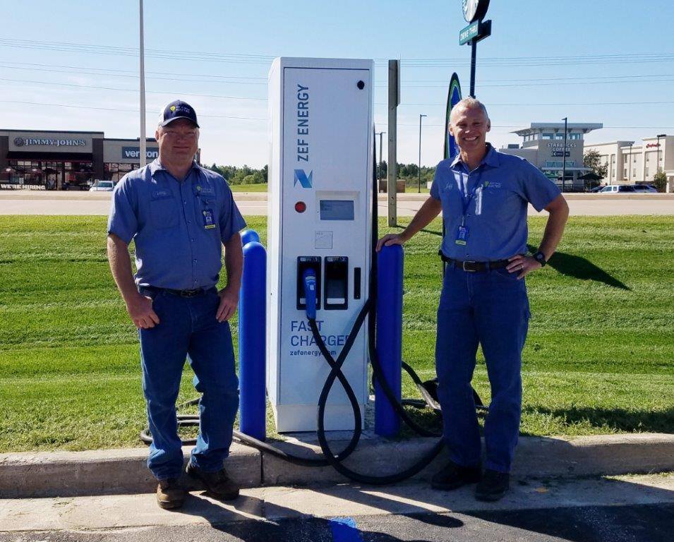 Gray Electric electricians beside a completed EV fast-charging station install