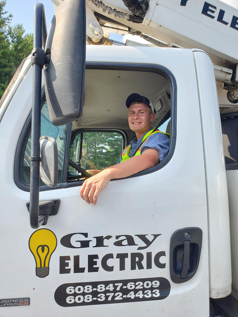 A Gray Electric technician arriving on site in a bucket truck